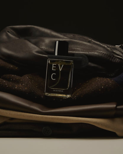 Swapped Leather by EVC resting against a worn leather bag and textured fabric